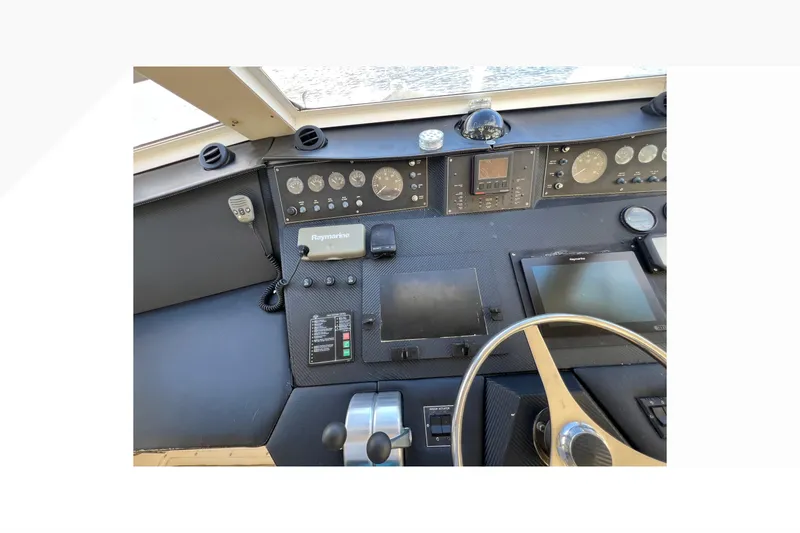 Slide: The Image of Cockpit of 1999 Viking 60 CPMY yacht with navigation instruments and steering wheel. - 43
