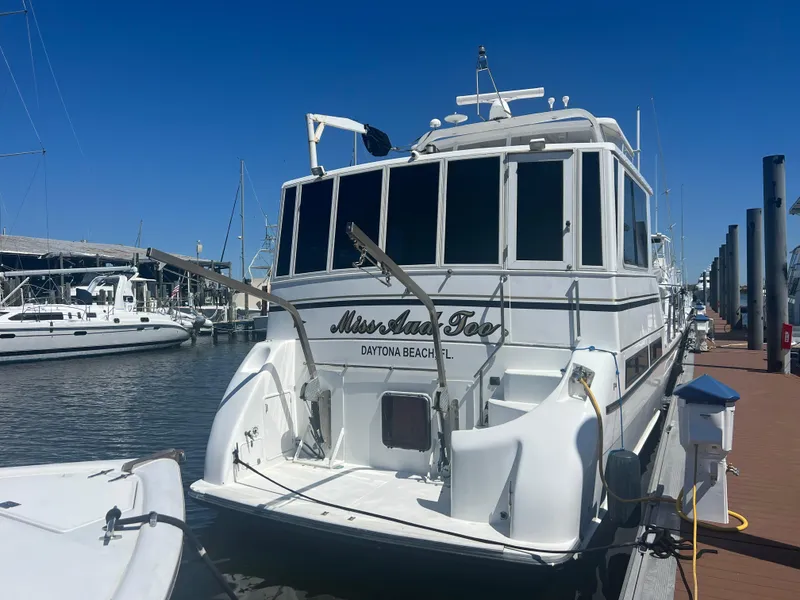 Slide: The Image of 1998 Hyatt 51 Aft Cabin Motor Yacht docked at marina under clear blue sky. - 6