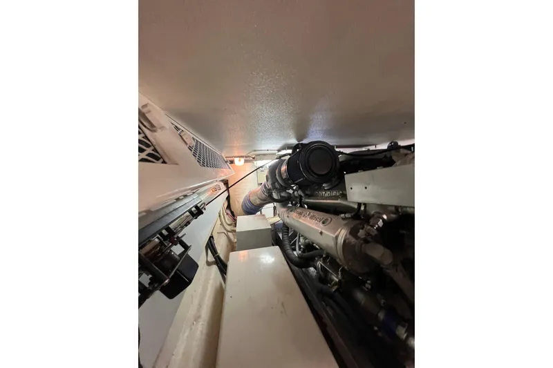 Slide: The Image of Engine room of a 1991 Viking Convertible boat, showcasing mechanical components. - 76