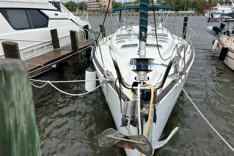 Slide: The Image of 2001 Beneteau Oceanis 473 sailboat docked at marina, front view. - 2