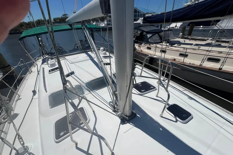 Slide: The Image of 2001 Beneteau Oceanis 473 sailboat deck view at marina, showcasing rigging and hatches. - 18