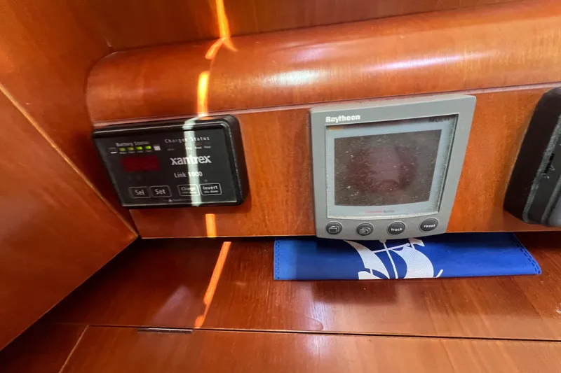 Slide: The Image of Control panel on a 2001 Beneteau Oceanis 473 yacht, featuring Xantrex and Raytheon displays. - 79