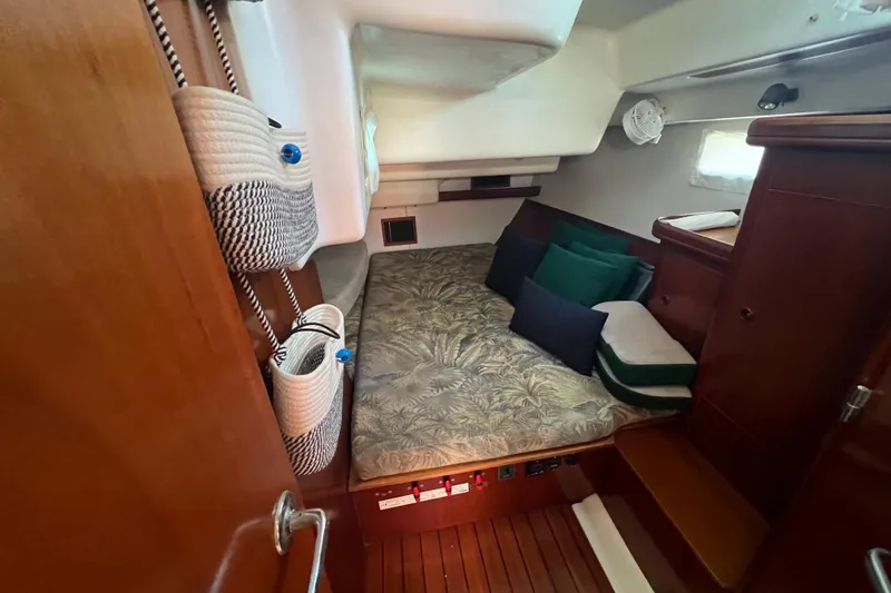 Slide: The Image of Cozy cabin interior of 2001 Beneteau Oceanis 473 sailboat with cushions and storage. - 81