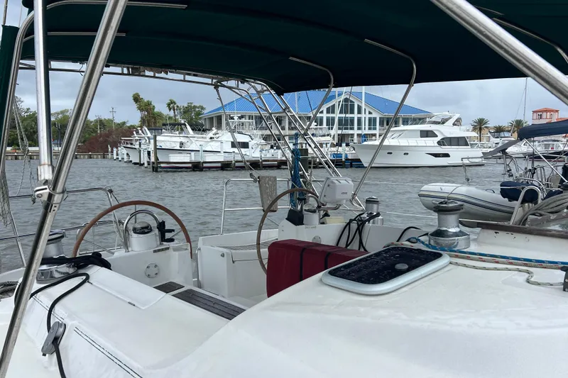 Slide: The Image of Cockpit view of 2001 Beneteau Oceanis 473 sailboat docked at marina with yachts. - 6
