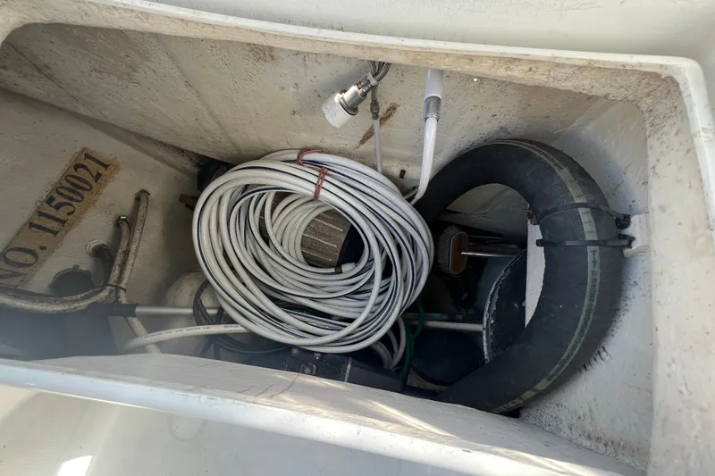 Slide: The Image of Storage compartment of a 2001 Beneteau Oceanis 473 sailboat with coiled cables and equipment. - 49