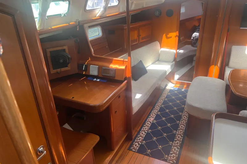 Slide: The Image of Interior of 2001 Beneteau Oceanis 473 yacht with wooden furnishings and cozy seating area. - 55
