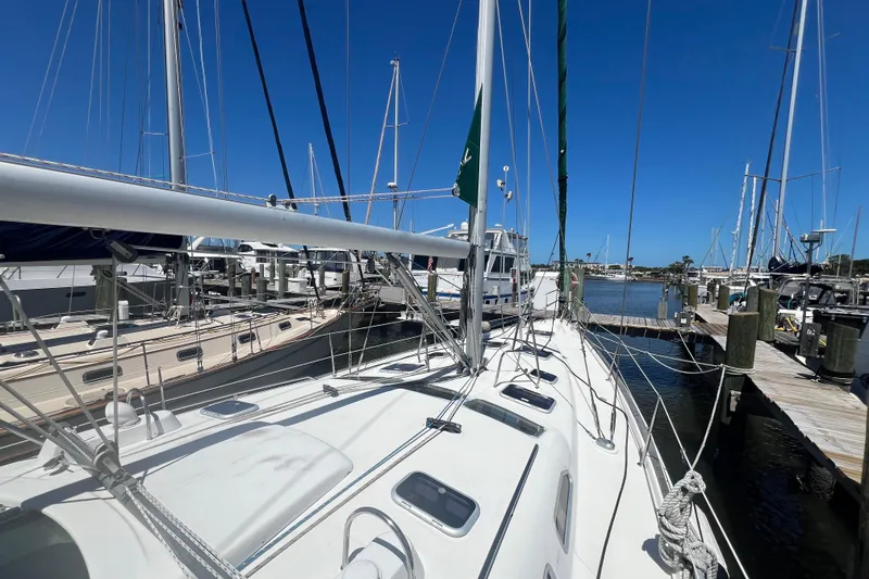 Slide: The Image of 2001 Beneteau Oceanis 473 sailboat docked at marina under clear blue sky. - 13