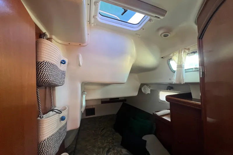 Slide: The Image of Interior cabin of 2001 Beneteau Oceanis 473 sailboat, featuring cozy sleeping area and storage. - 82