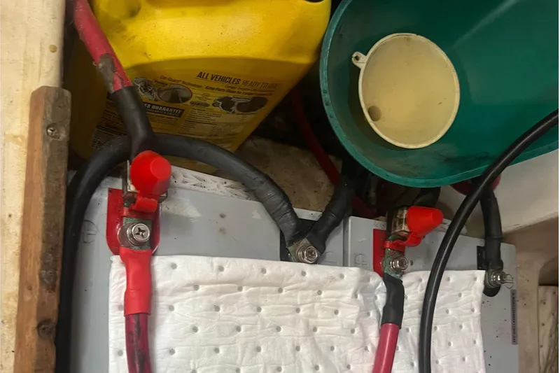 Slide: The Image of Battery compartment of a 2001 Beneteau Oceanis 473 with cables and containers. - 105