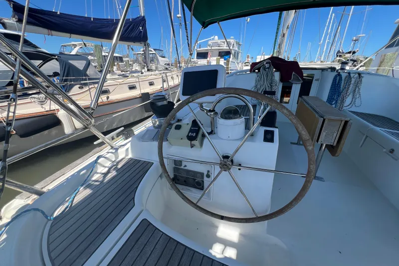 Slide: The Image of Cockpit of 2001 Beneteau Oceanis 473 sailboat with steering wheel and navigation equipment. - 46