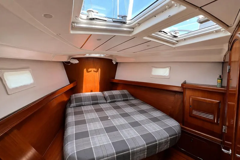 Slide: The Image of Luxurious cabin interior of a 2001 Beneteau 473 yacht with skylights and wood finish. - 90
