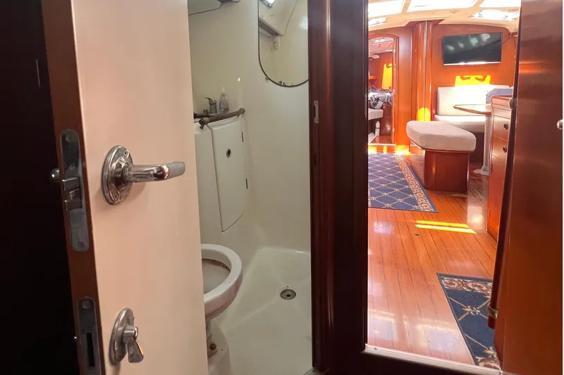 Slide: The Image of Interior view of 2001 Beneteau Oceanis 473 yacht, featuring bathroom and cozy living area. - 85