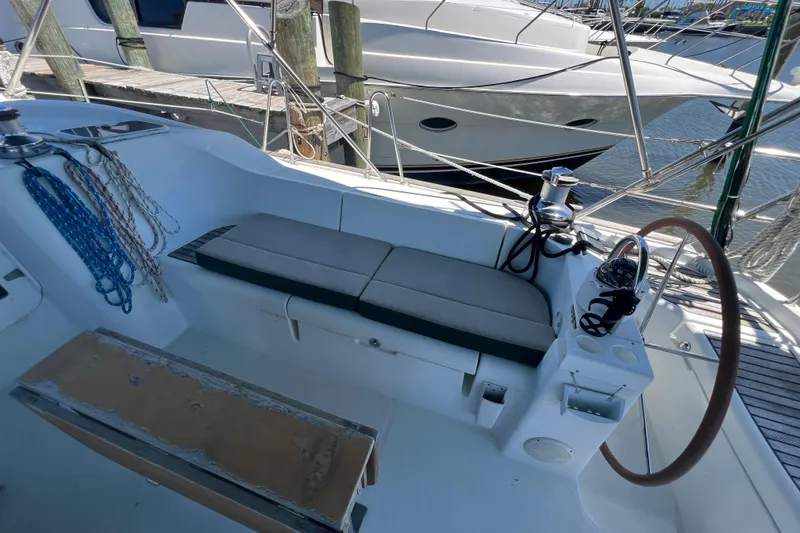 Slide: The Image of Cockpit of 2001 Beneteau Oceanis 473 sailboat with seating and steering wheel. - 38