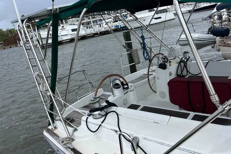 Slide: The Image of Beneteau Oceanis 473 sailboat, 2001 model, docked at marina with visible cockpit and equipment. - 5