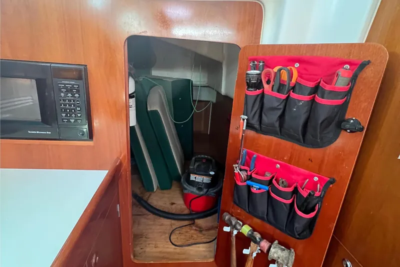 Slide: The Image of Interior of 2001 Beneteau Oceanis 473 sailboat with organized tool storage. - 70