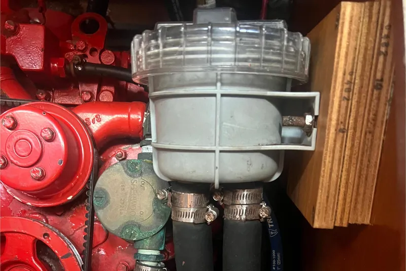 Slide: The Image of Engine compartment of a 2001 Beneteau Oceanis 473 sailboat, showcasing mechanical components. - 106