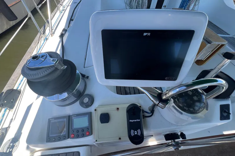 Slide: The Image of Cockpit of 2001 Beneteau Oceanis 473 sailboat with navigation equipment and steering wheel. - 52