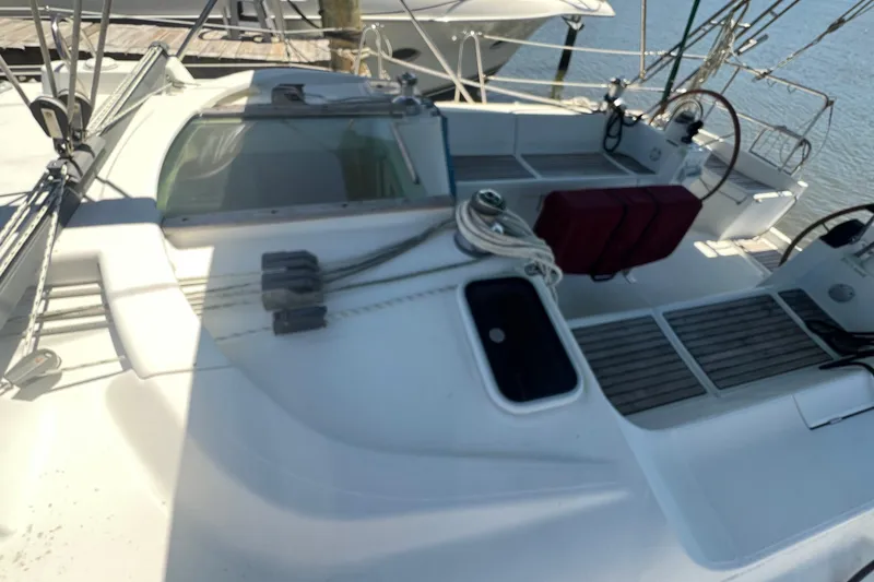 Slide: The Image of 2001 Beneteau Oceanis 473 sailboat cockpit with steering wheel and deck details. - 28