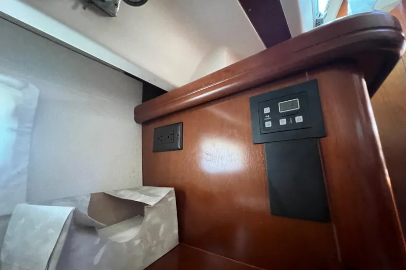 Slide: The Image of Interior of 2001 Beneteau Oceanis 473 yacht with control panel and wooden finish. - 87