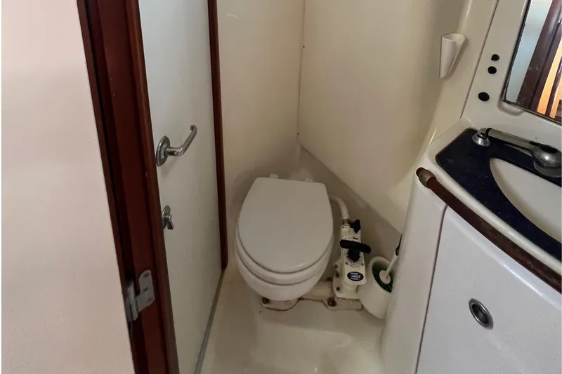 Slide: The Image of Bathroom interior of 2001 Beneteau Oceanis 473 yacht, featuring toilet and sink. - 98