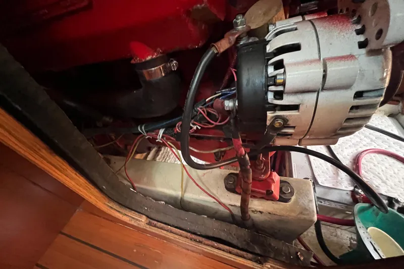 Slide: The Image of Engine compartment of a 2001 Beneteau Oceanis 473 sailboat, showing alternator and wiring. - 114