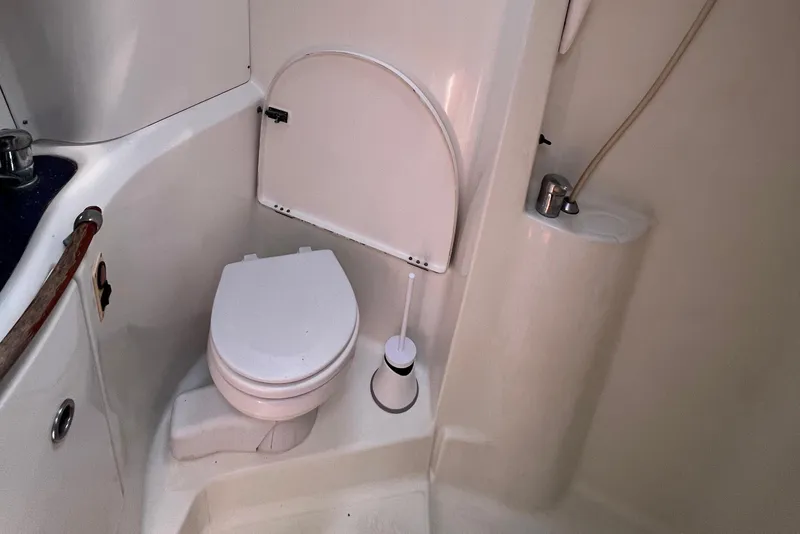 Slide: The Image of Compact bathroom in 2001 Beneteau Oceanis 473 yacht, featuring toilet and shower. - 96
