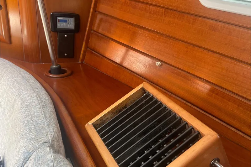 Slide: The Image of Interior of 2001 Beneteau Oceanis 473 yacht with wooden paneling and remote control. - 58