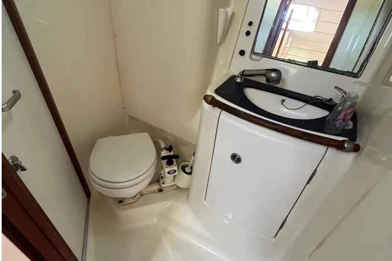 Slide: The Image of Bathroom interior of 2001 Beneteau Oceanis 473 yacht, featuring toilet and sink. - 99