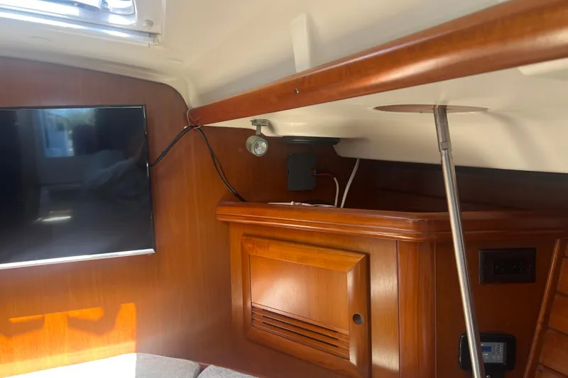 Slide: The Image of Interior of 2001 Beneteau Oceanis 473 yacht with wooden cabinetry and mounted TV. - 61