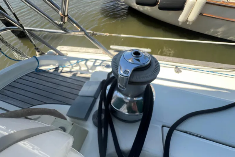 Slide: The Image of Winch on deck of 2001 Beneteau Oceanis 473 sailboat, docked by water. - 34