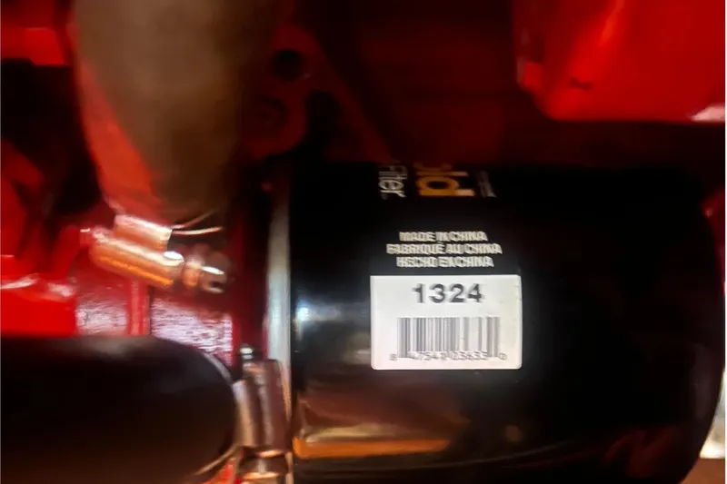 Slide: The Image of Engine component of a 2001 Beneteau Oceanis 473 sailboat, featuring a filter with barcode. - 111