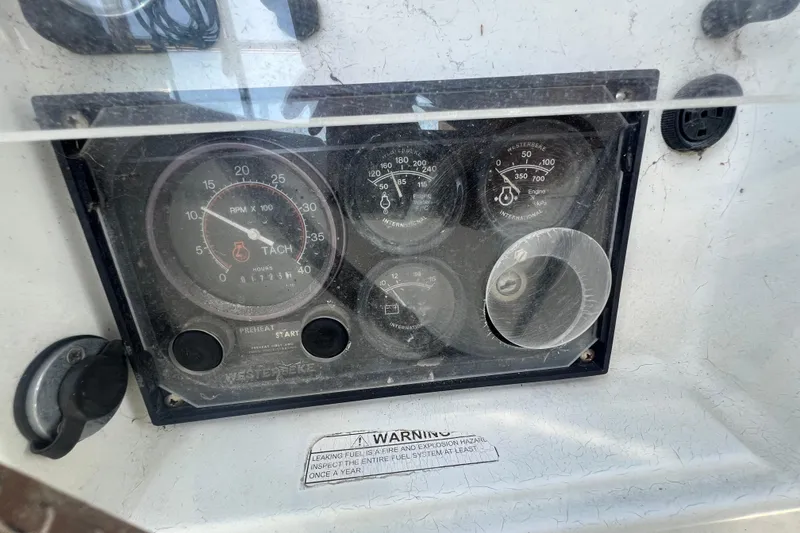 Slide: The Image of Control panel of a 2001 Beneteau Oceanis 473 sailboat, featuring gauges and warning label. - 47