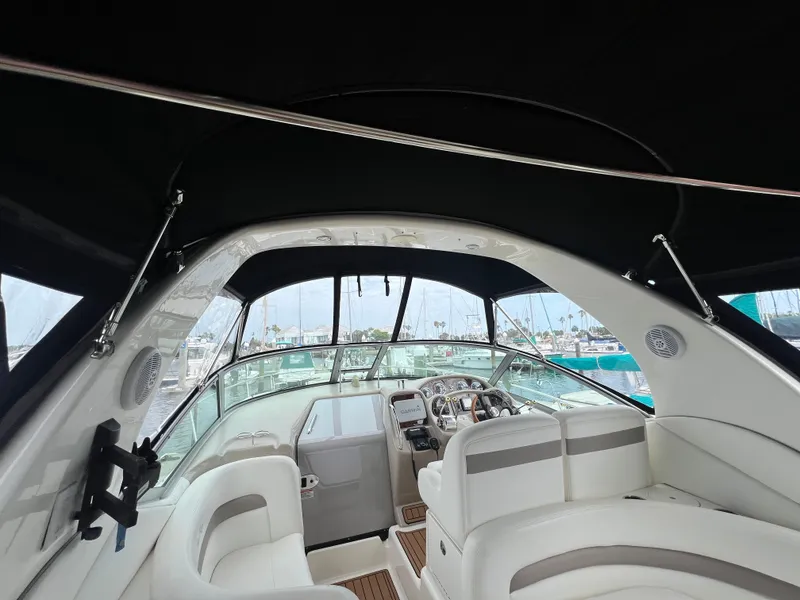 Slide: The Image of Interior view of 2003 Sea Ray 320 Sundancer yacht with white seating and helm. - 33