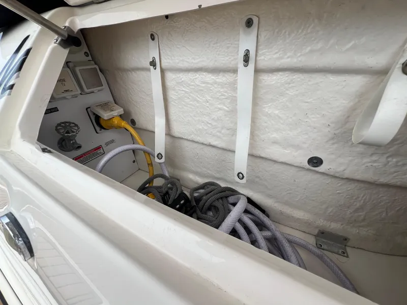 Slide: The Image of Storage compartment of 2003 Sea Ray 320 Sundancer with ropes and electrical connections. - 41