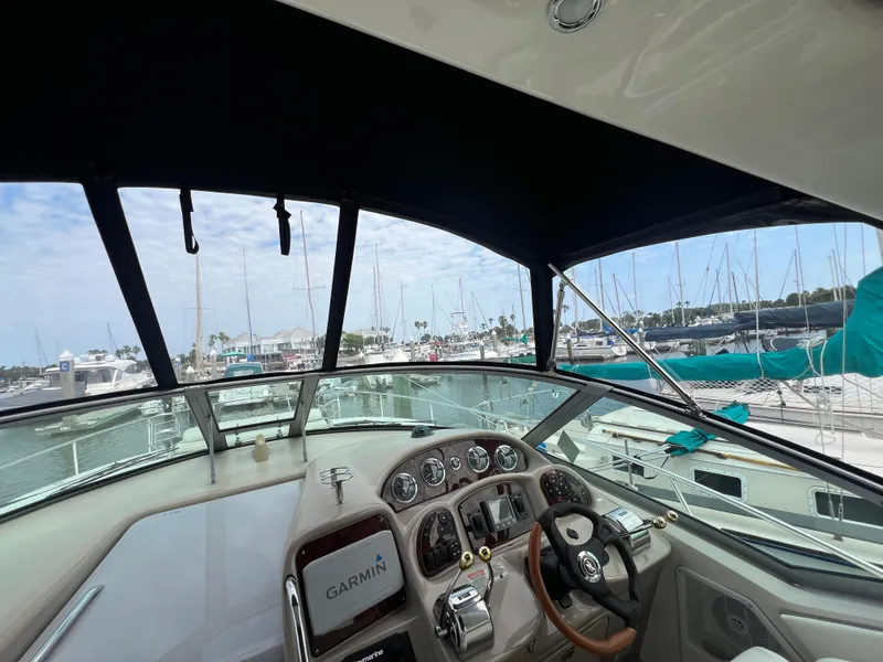 Slide: The Image of 2003 Sea Ray 320 Sundancer helm with Garmin navigation, docked at marina. - 15
