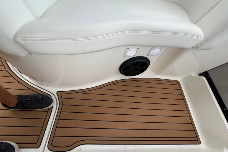 Slide: The Image of 2003 Sea Ray 320 Sundancer interior with teak flooring and cushioned seating. - 31