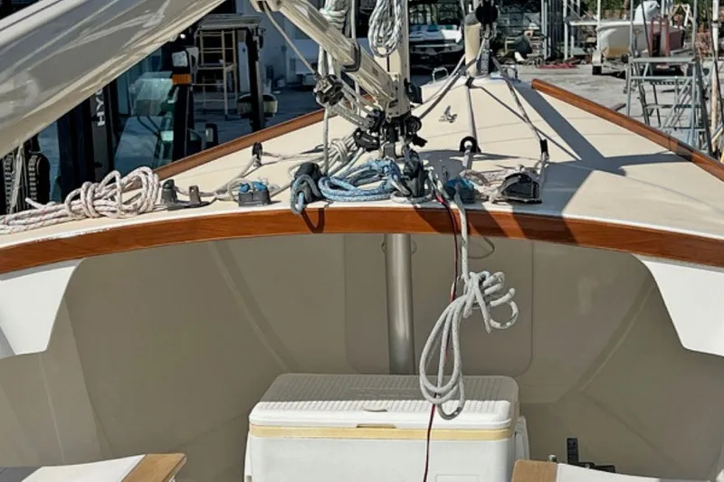Slide: The Image of 2019 Alerion Express 20 sailboat deck with ropes and equipment in a marina setting. - 11