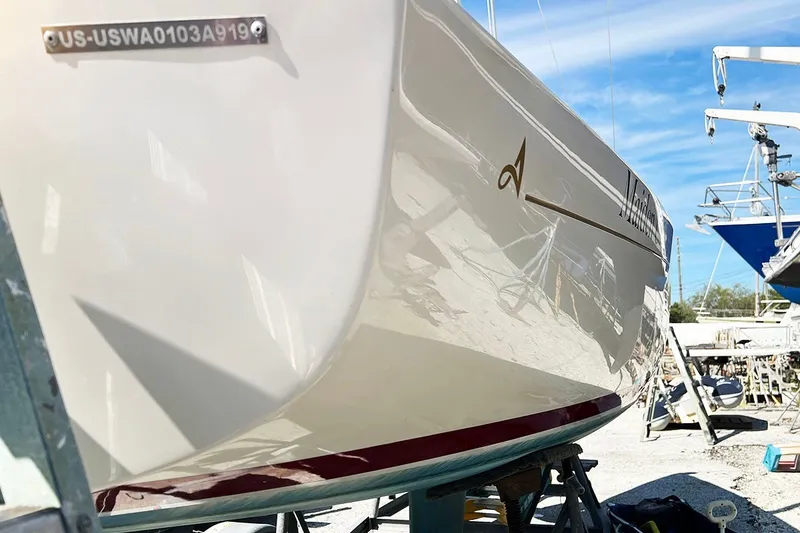 Slide: The Image of 2019 Alerion Express 20 sailboat on dry dock, showcasing sleek hull design. - 3