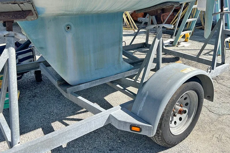 Slide: The Image of Trailer carrying a 2019 Alerion Express 20 sailboat, parked on a sunny day. - 5