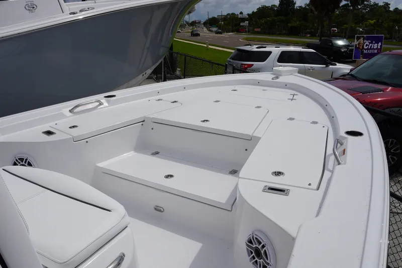 Slide: The Image of 2027 Sportsman Masters 247 Bay Boat, spacious deck view, white finish, parked outdoors. - 13
