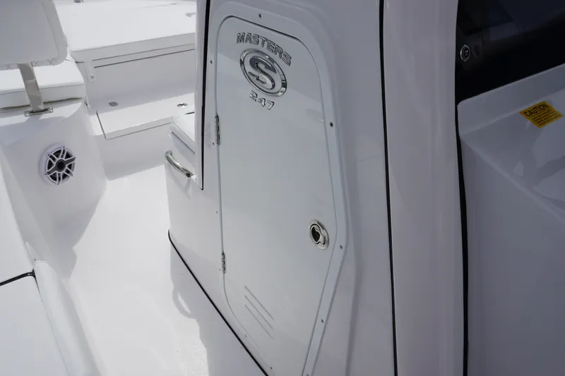 Slide: The Image of 2027 Sportsman Masters 247 Bay Boat interior, featuring sleek white design and storage compartment. - 21