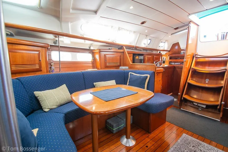 Slide: The Image of Interior of 2005 Beneteau Oceanis 423 yacht with wooden furnishings and cozy seating area. - 21
