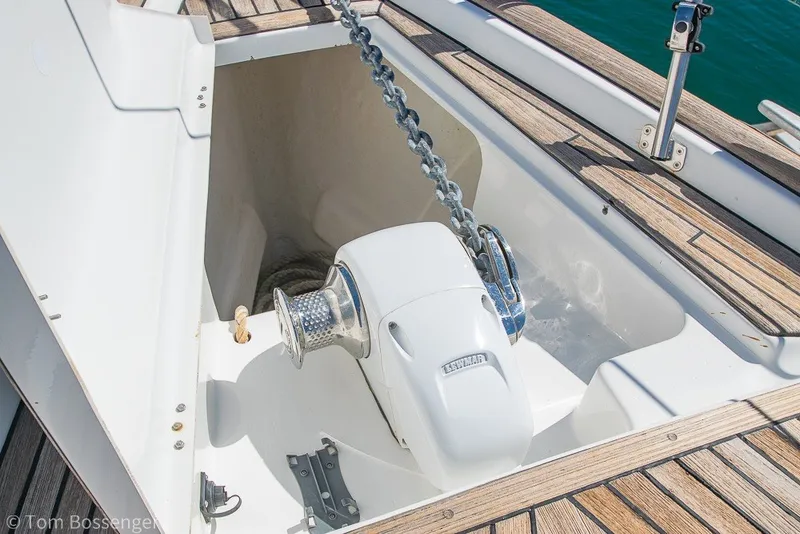 Slide: The Image of Anchor windlass on 2005 Beneteau Oceanis 423 sailboat deck, featuring teak wood finish. - 66