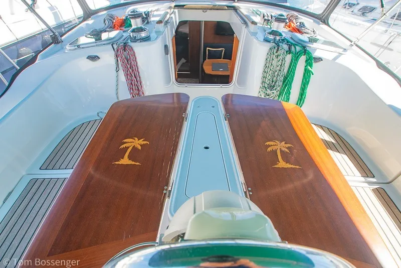 Slide: The Image of Cockpit of 2005 Beneteau Oceanis 423 sailboat with wooden table and palm tree design. - 43