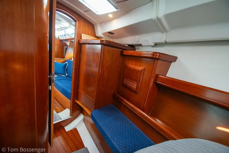 Slide: The Image of Interior of 2005 Beneteau Oceanis 423 yacht with polished wood and blue upholstery. - 29