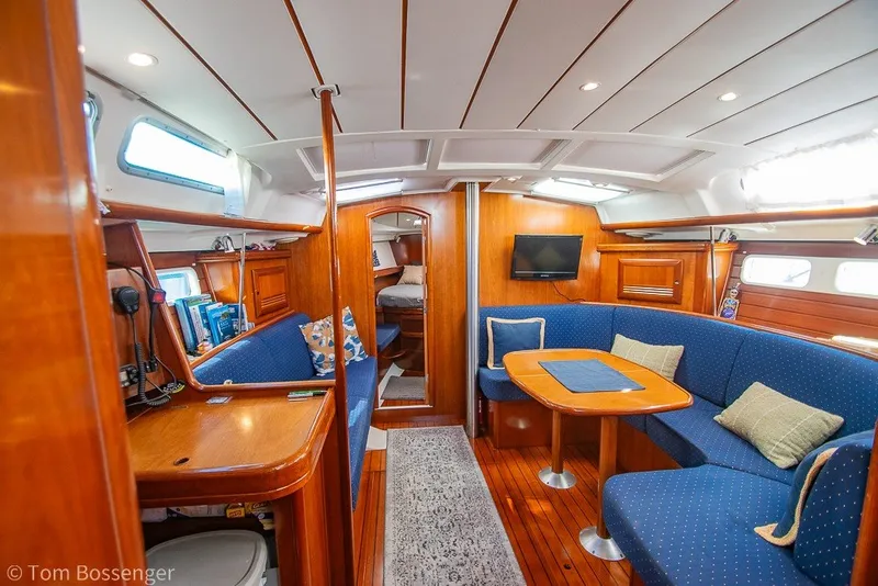 Slide: The Image of Interior of 2005 Beneteau Oceanis 423 yacht with cozy seating and wooden finishes. - 10