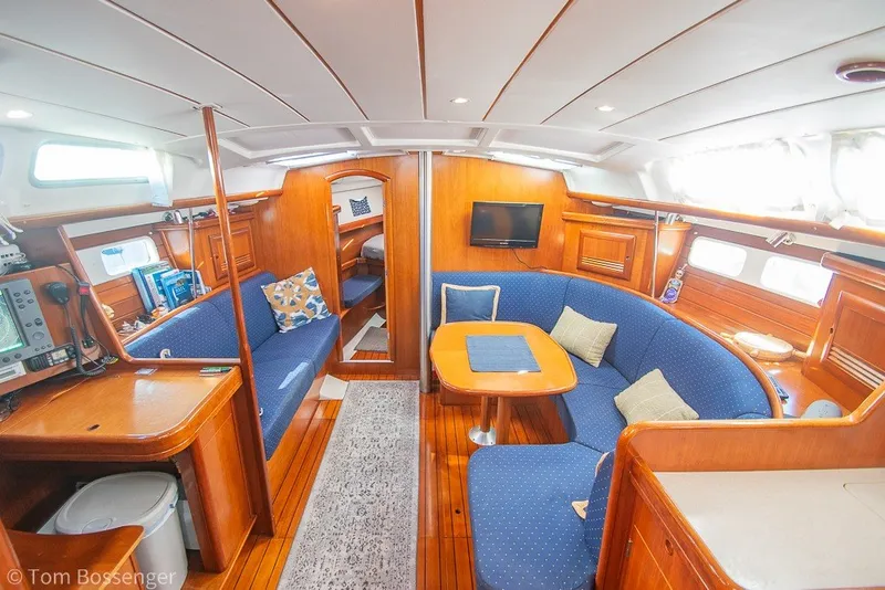 Slide: The Image of Interior of 2005 Beneteau Oceanis 423 yacht with cozy seating and wooden finishes. - 9