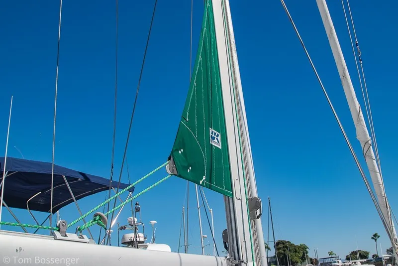 Slide: The Image of Sailboat Beneteau Oceanis 423, 2005 model, with green sail against clear blue sky. - 58