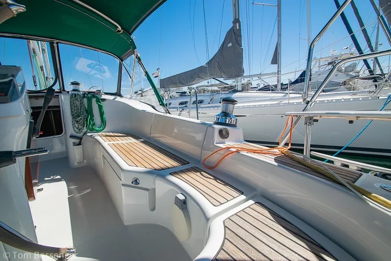 Slide: The Image of 2005 Beneteau Oceanis 423 sailboat cockpit with teak seating and marina view. - 36
