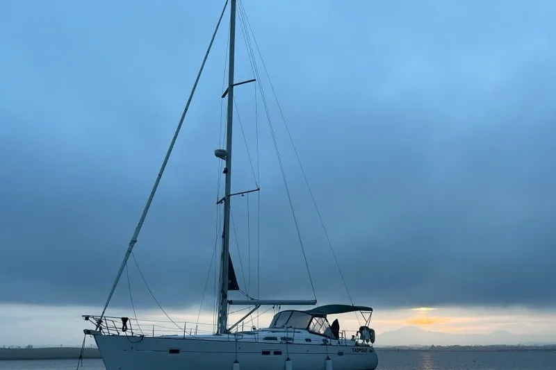 Slide: The Image of 2005 Beneteau Oceanis 423 sailboat at sunset on calm waters. - 1